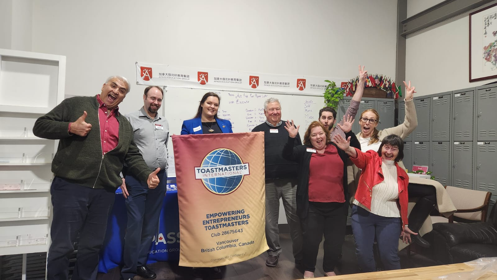Toastmasters club team photo in front of the club banner
